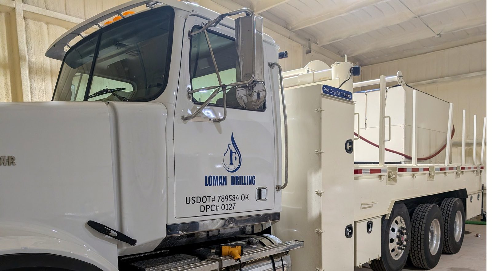 Loman Drilling flatbed fleet truck with branded graphics, Shawnee OK